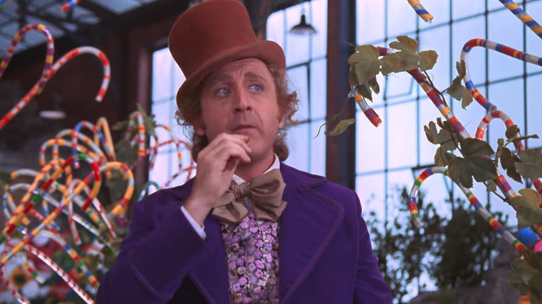 Gene Wilder as Willy Wonka eating candy in his chocolate factory